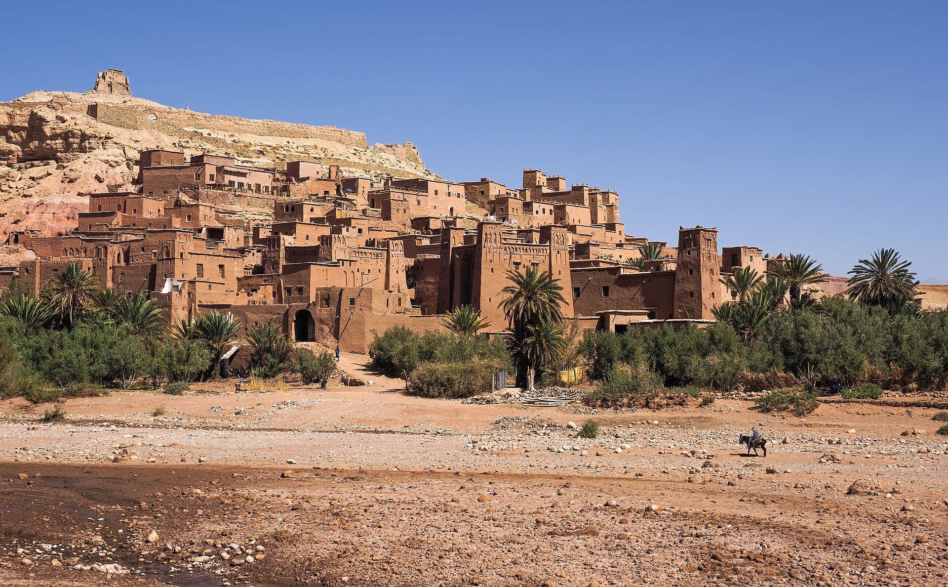 The earthen ksar of Aït Benhaddou by the river, with the kasbah on the hill