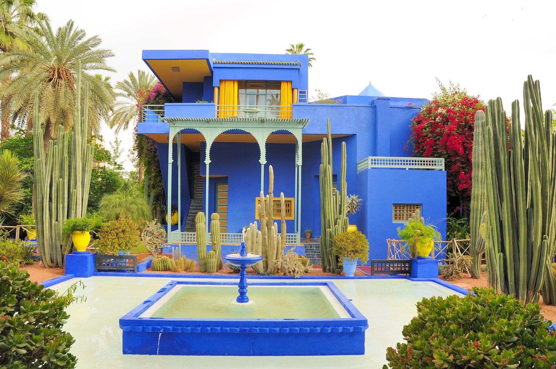 The cobalt blue house and the pond in the Jardin Majorelle in Marrakesh