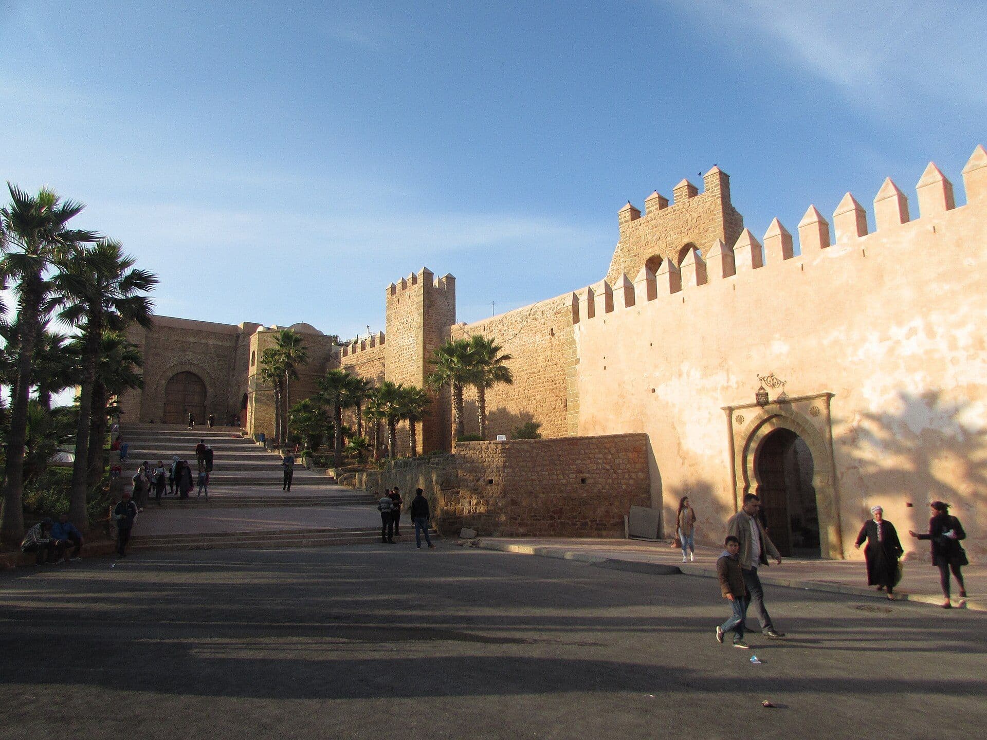 The city walls and the gate of the Kasbah of the Oudayas in Rabat, with palm trees in front