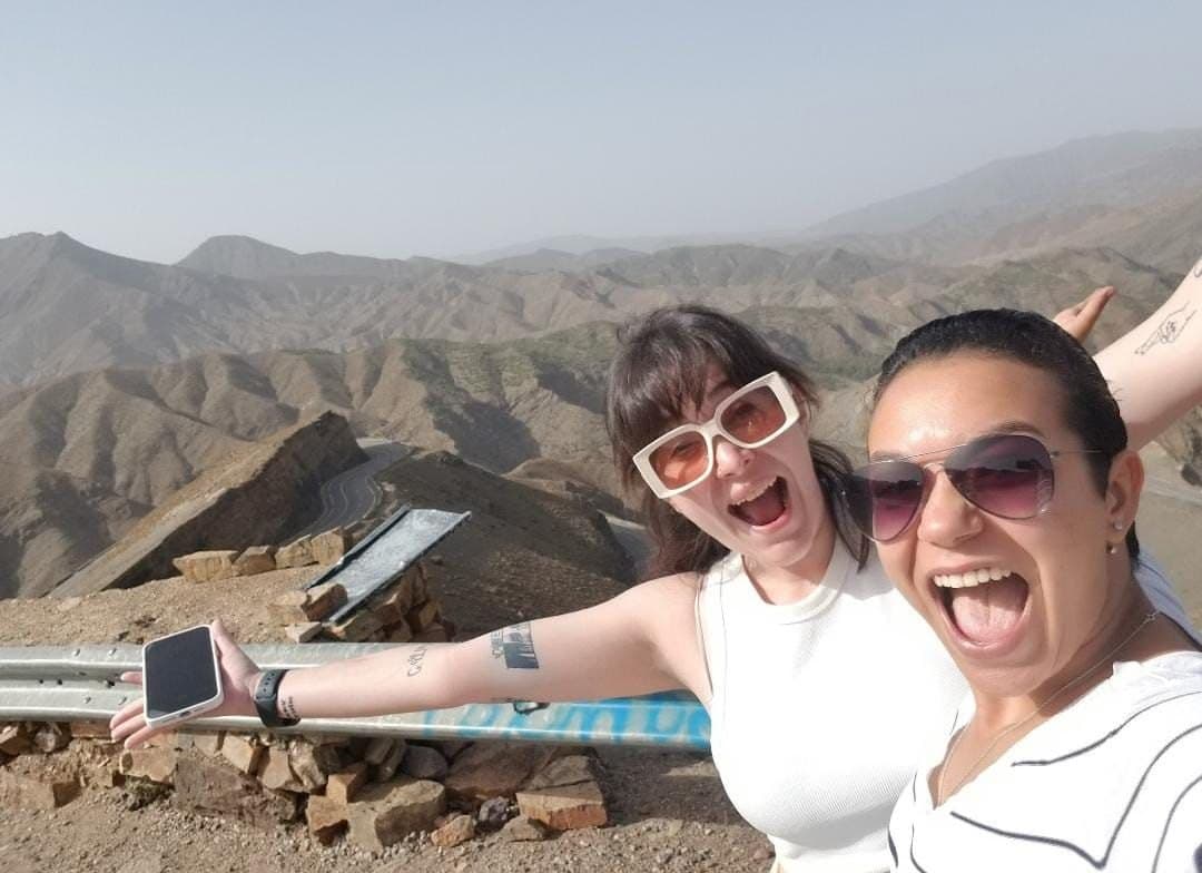 Soukayna (right, in sunglasses) with a traveler on a mountain pass in the Atlas